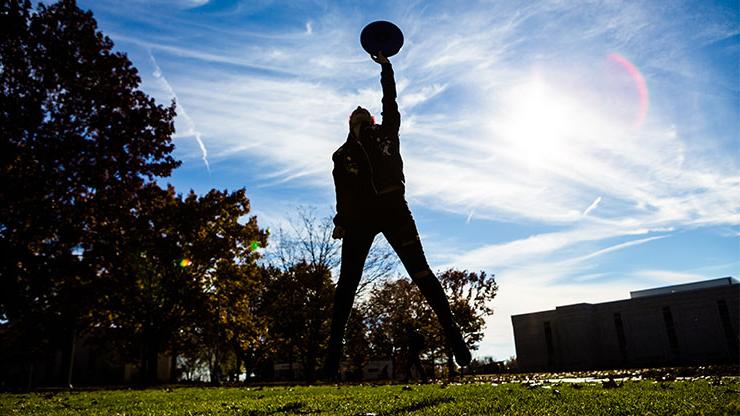 Person catching frisbee mid-air